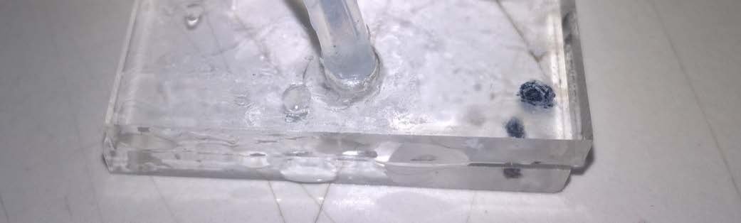 Figure 9: Prototype Microfluidic chip, leakage of liquid between top and bottom components when sealed with superglue.